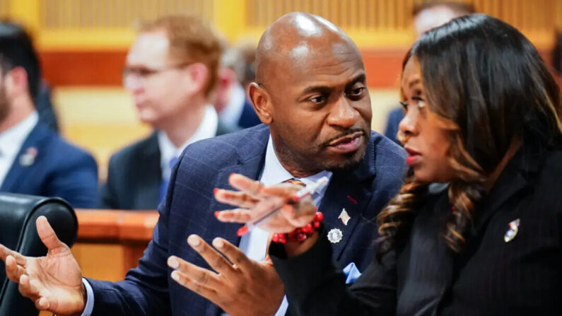 Fulton County special prosecutor Nathan Wade (L) and executive district attorney Daysha Young confer during a hearing in the election interference case against President Trump, at the Fulton County Courthouse in Atlanta, Ga., on Dec. 1, 