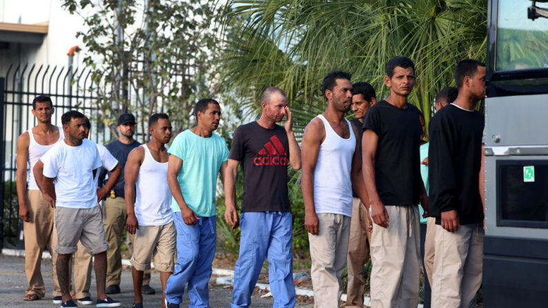 Migrantes de Cuba hacen fila para abordar un autobús que los llevará a una estación de Aduanas y Protección Fronteriza de EE. UU. mientras son procesados ​​el 5 de enero de 2023 en Marathon, Florida.. (Joe Raedle/Getty Images)