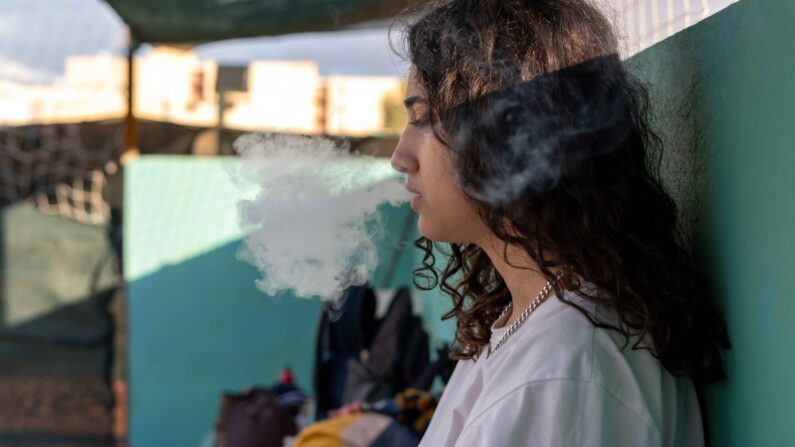 Imagen de archivo de una joven fumando un cigarro electrónico. (MOJ/Middle East Images/AFP vía Getty Images)
