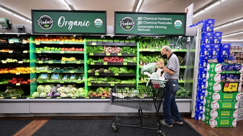 A shopper looks at organic produce at a supermarket in Montebello, California, on August 23, 2022. - US shoppers are facing increasingly high prices on everyday goods and services as inflation continues to surge with high prices for groceries, gasoline, and housing. (Photo by Frederic J. BROWN / AFP) (Photo by FREDERIC J. BROWN/AFP via Getty Images)