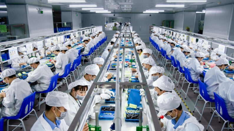 Trabajadores fabrican vainas para cigarrillos electrónicos en la línea de producción de Kanger Tech, uno de los principales fabricantes chinos de productos vaping, en Shenzhen, China, el 24 de septiembre de 2019. (Kevin Frayer/Getty Images)