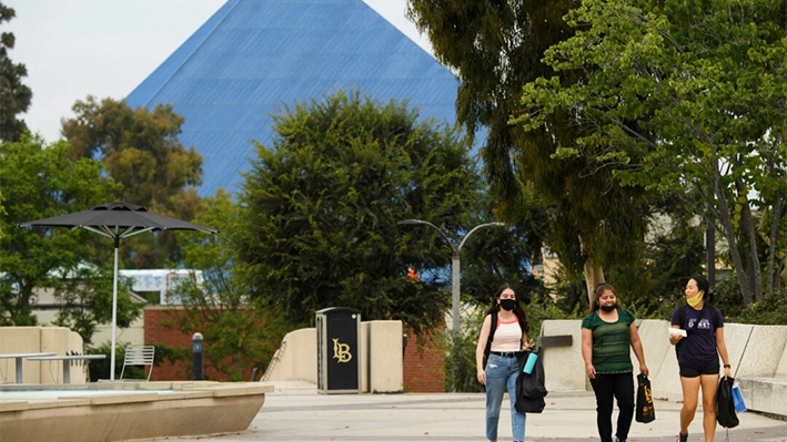 Un grupo de personas camina por el campus de la Universidad Estatal de California de Long Beach (CSULB) en Long Beach, California, el 11 de agosto de 2021. (Patrick T. Fallon/AFP vía Getty Images)

