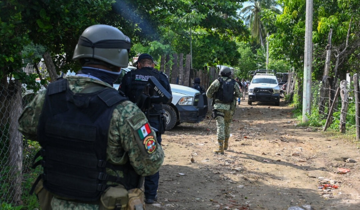 Fuerzas de seguridad inspeccionan la zona donde al menos 11 policías murieron en una emboscada de grupos criminales en Coyuca de Benítez, estado de Guerrero, México, el 23 de octubre de 2023. (Francisco Robles/AFP vía Getty Images)
