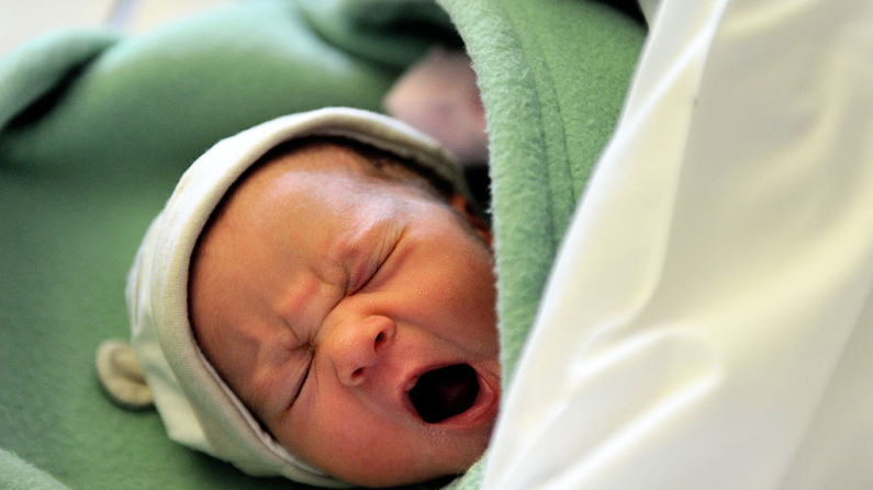 A new born cries on September 17, 2013 at the maternity of the Lens hospital, northern France. AFP PHOTO PHILIPPE HUGUEN        (Photo credit should read PHILIPPE HUGUEN/AFP via Getty Images)