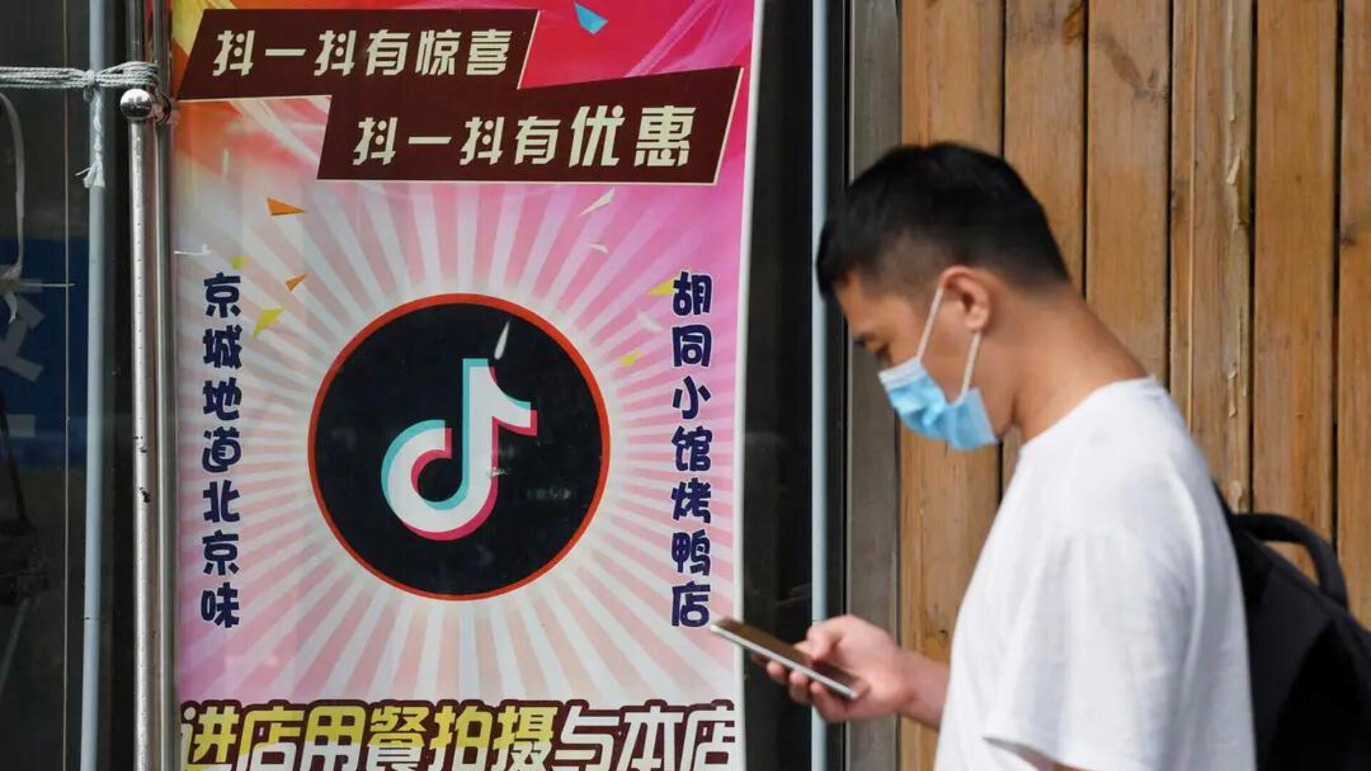 Un hombre pasa por un restaurante con el logotipo de TikTok en la ventana en Beijing el 14 de septiembre de 2020. 
