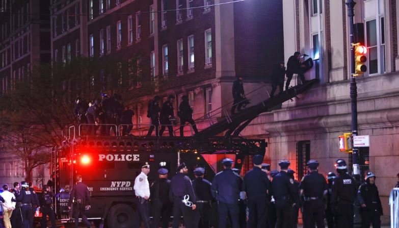 Agentes de policía de Nueva York con equipo antidisturbios irrumpen en un edificio de la Universidad de Columbia, donde estudiantes pro-Palestina están atrincherados en el interior de un edificio y han establecido un campamento, en la ciudad de Nueva York el 30 de abril de 2024. (Kena Betancur/AFP)