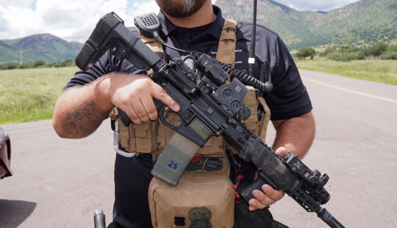 Kyle, profesional de la seguridad privada, lleva un rifle semiautomático AR-15 como protección personal antes de entrar en un conocido «punto caliente» de tráfico de personas en el Bosque Nacional Coronado, en el sur de Arizona. (Allan Stein/The Epoch Times)