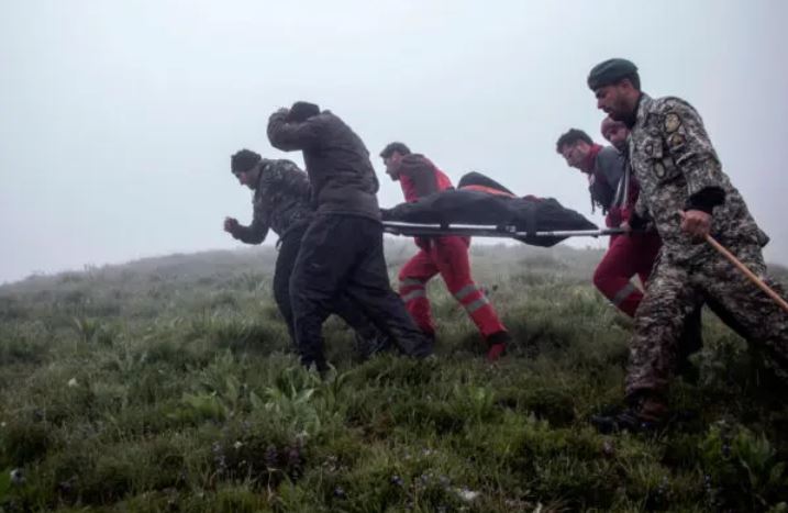 Rescatistas recuperan cuerpos en el lugar donde se estrelló un helicóptero que transportaba al presidente de Irán, a su ministro de Asuntos Exteriores y a otras personas en Varzaghan, en el noroeste de Irán, el 20 de mayo de 2024. (Azin Haghighi/AFP vía Getty Images)