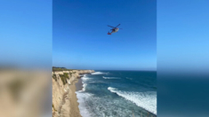 Rescatan a surfista de kitesurf varado en playa de California tras deletrear “ayuda” con rocas