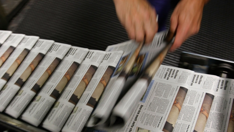 SAN FRANCISCO - SEPTEMBER 20:  San Francisco Chronicle journeyman pressman Ray Lussier pulls two freshly printed copies of the Chronicle at one of the Chronicle's printing facilities September 20, 2007 in San Francisco, California. Newspaper sales in the U.S. continue to slide as people turn to the internet and television for their news. The Chronicle saw its circulation plunge more than 15 percent in 2006 to 398,000 during the week which has hurt newspaper vendor Rick Gaub's business. Unable to sell as many papers as he used to, Gaub is looking for a new way to earn money after selling papers for 42 years.  (Photo by Justin Sullivan/Getty Images)