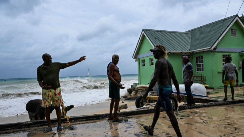 Residentes retiran un bote de la calle inundada tras el paso del huracán Beryl en la parroquia de Saint James, Barbados, cerca de Bridgetown, Barbados, el 1 de julio de 2024. (Chandan Khanna/AFP vía Getty Images)