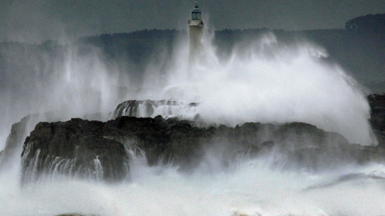 El oleaje rompe frente y sobre la isla de Mouro, en la bocana del puerto de Santander. EFE/Esteban Cobo