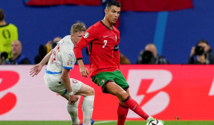 Portugal's Cristiano Ronaldo (R), and Czech Republic's David Jurasek challenge for the ball during a Group F match between Portugal and Czech Republic at the Euro 2024 soccer tournament in Leipzig, Germany, on June 18, 2024. (Sunday Alamba/AP Photo)