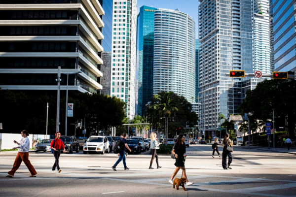 La gente cruza la intersección de SW 8th Steet y Brickell Ave. en el barrio de Brickell, conocido como el distrito financiero, en Miami, Florida, el 23 de febrero de 2023. (Marco Bello/REUTERS)