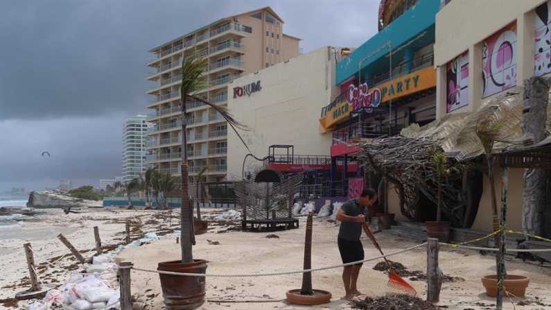 Fotografía donde se observa a personal limpiando sus negocios después del paso del huracán en las principales playas el 5 de julio de 2024, en el balneario de Cancún en Quintana Roo (México). EFE/ Lourdes Cruz