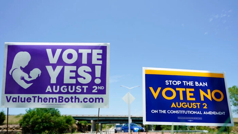 Carteles a favor y en contra de una enmienda constitucional de Kansas sobre el aborto se exhiben afuera de la autopista Kansas 10, en Lenexa, Kansas, el 1 de agosto de 2022. (Kyle Rivas/Getty Images)