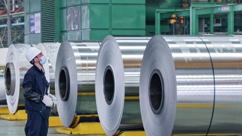 Un empleado observa unos rollos de acero en una fábrica de Nantong, en la provincia oriental china de Jiangsu, el 1 de marzo de 2022. (STR/AFP vía Getty Images)