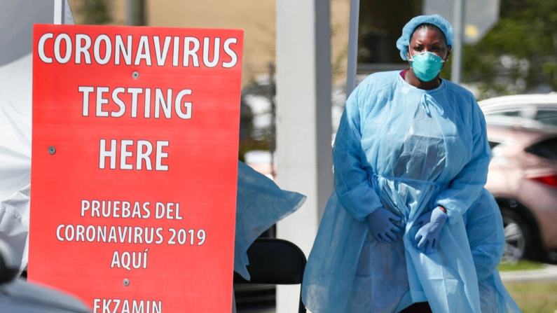 Un miembro del personal sanitario de Community Health of South Florida, Inc. (CHI) se prepara para realizar pruebas de COVID-19 a las personas en el aparcamiento de su Centro de Salud Doris Ison en Miami, Florida, el 18 de marzo de 2020. (Joe Raedle/Getty Images)