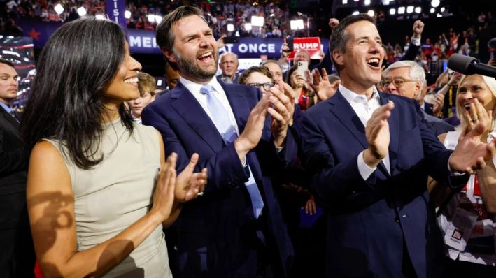 El senador JD Vance (R-Ohio) celebra su nominación al cargo de vicepresidente junto a su esposa, Usha Chilukuri Vance, y el delegado de Ohio Bernie Moreno en el primer día de la Convención Nacional Republicana en el Foro Fiserv en Milwaukee el 15 de julio de 2024. (Anna Moneymaker/Getty Images)