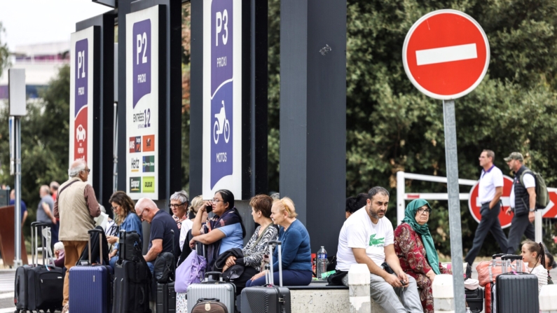 Los pasajeros esperan fuera del Aeropuerto de Toulouse-Blagnac en Blagnac, en el suroeste de Francia, el 18 de octubre de 2023, después de que el aeropuerto fuera evacuado. Seis aeropuertos en toda Francia fueron evacuados el 18 de octubre de 2023 tras recibir "amenazas de ataque" por correo electrónico, según informó una fuente policial a la AFP. (CHARLY TRIBALLEAU/AFP via Getty Images)