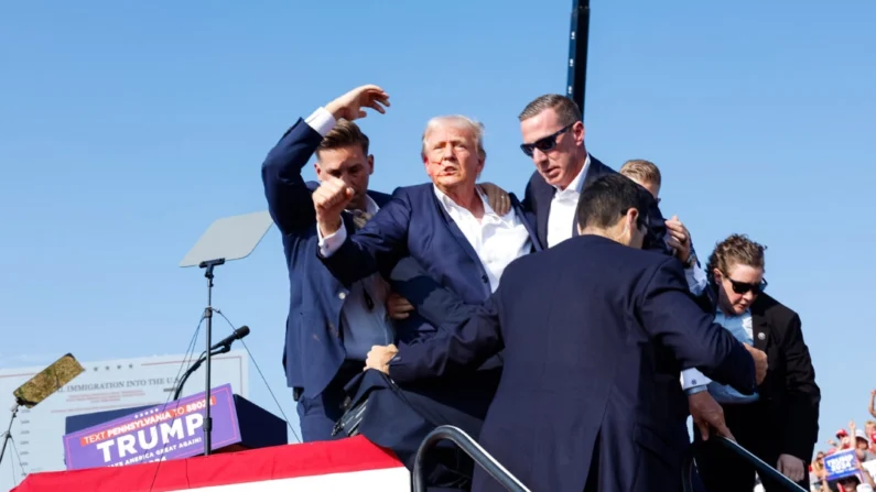 El candidato presidencial republicano, el expresidente Donald Trump, es sacado del escenario rápidamente tras un intento de asesinato durante un mitin en Butler, Pensilvania, el 13 de julio de 2024. (Anna Moneymaker/Getty Images)