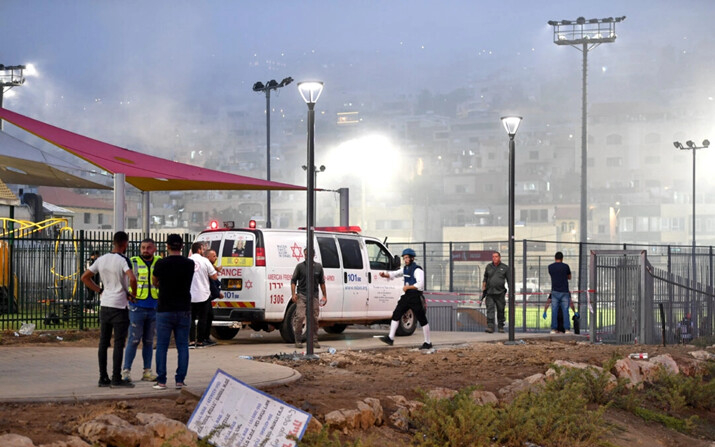 Las autoridades israelíes llegan al sitio donde impactaron cohetes lanzados a través de la frontera del Líbano con Israel. Según los servicios de emergencia de Israel, los cohetes mataron a varias personas en un campo de fútbol, en Majdal Shams, una aldea drusa en los Altos del Golán, el 27 de julio de 2024. (Gil Eliyahu/Reuters)