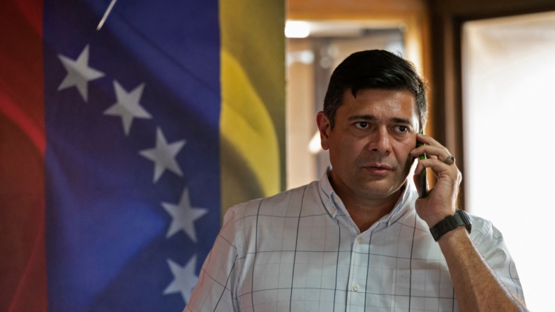 El ex candidato a gobernador del estado Barinas por el partido opositor Voluntad Popular, Freddy Superlano, habla por su teléfono móvil después de una conferencia de prensa en Caracas el 6 de diciembre de 2021. (YURI CORTEZ/AFP via Getty Images)