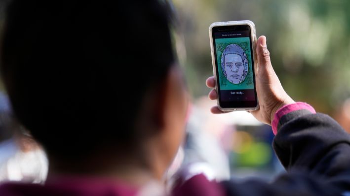 Un migrante de Michoacán, México, utiliza la aplicación CBPOne el martes, 24 de enero 2023, en Tijuana, México. (AP Photo/Gregory Bull, Archivo)
