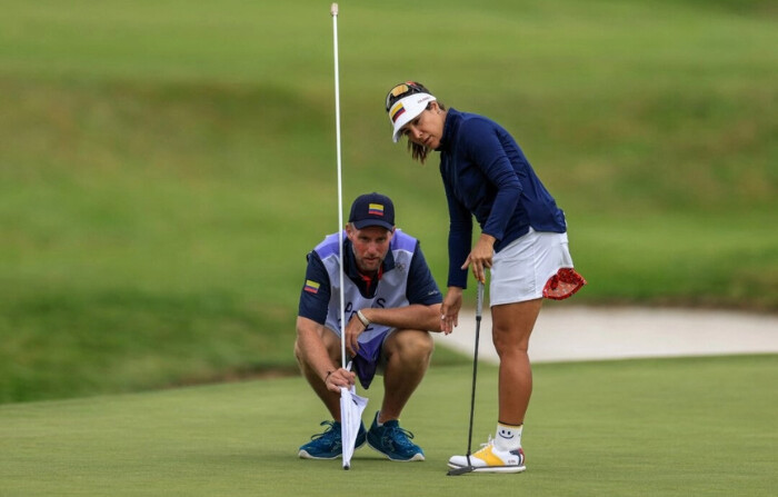 La colombiana María José Uribe consulta a su caddie antes de realizar el putt durante la tercera ronda del juego por golpes individual de golf femenino de los Juegos Olímpicos de París 2024 en Le Golf National de París el 9 de agosto de 2024. (Emmanuel Dunand/ AFP)
