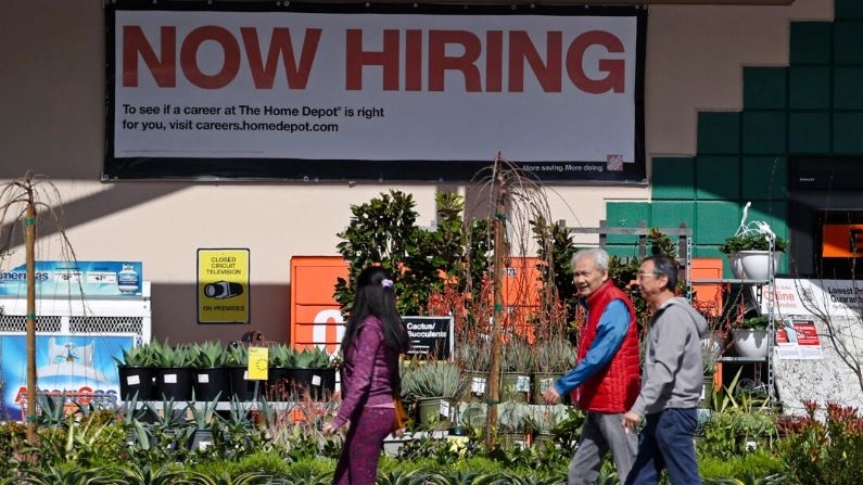 Clientes de Home Depot caminan junto a un cartel de «Ahora contratando» en San Rafael, California, el 8 de marzo de 2024. (Justin Sullivan/Getty Images)