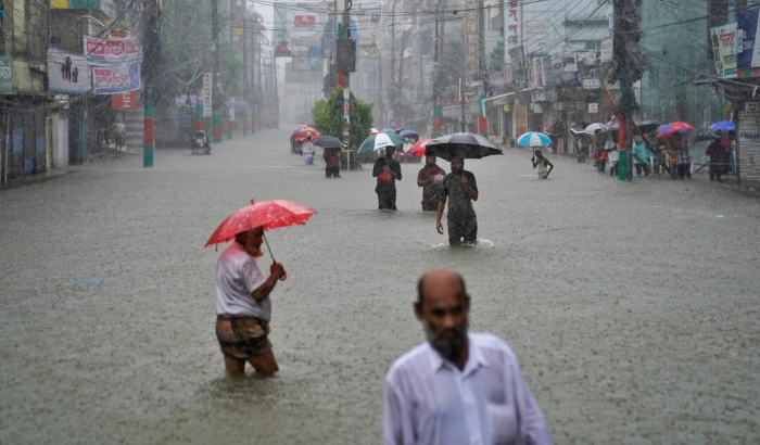 La gente navega por una calle inundada tras las incesantes lluvias en Feni, un distrito costero del sureste de Bangladesh que limita con el estado de india de Tripura, el 22 de agosto de 2024. (Foto AP).