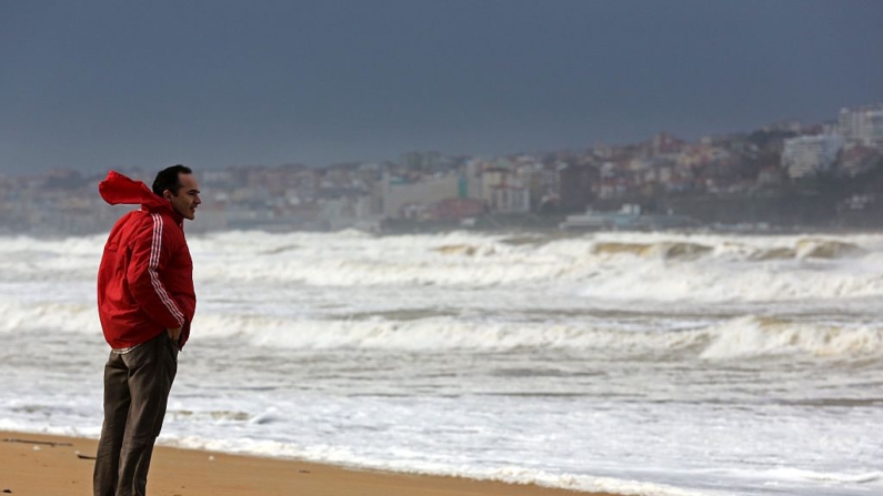 Un hombre mira las olas en la playa de Somo, cerca de Santander, el 31 de enero de 2015. (Cesar Manso/AFP vía Getty Images)