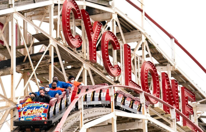 La gente viaja en la montaña rusa Cyclone de Coney Island en el distrito de Brooklyn de Nueva York el 9 de abril de 2021. (John Minchillo/Foto AP). 