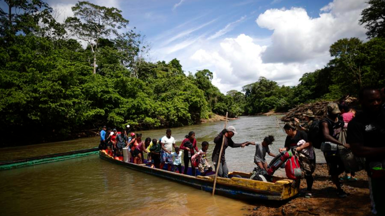 Fotografía de archivo de migrantes mientras descienden de una canoa antes de llegar a la Estación de Recepción Migratoria (ERM) de Lajas Blancas luego de atravesar la selva del Darién (Panamá). EFE/ Bienvenido Velasco