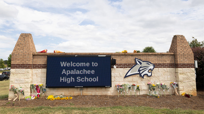 El letrero de entrada de Apalachee High School adornado con flores de los visitantes el 5 de septiembre de 2024 en Winder, Georgia. (Jessica McGowan/Getty Images)