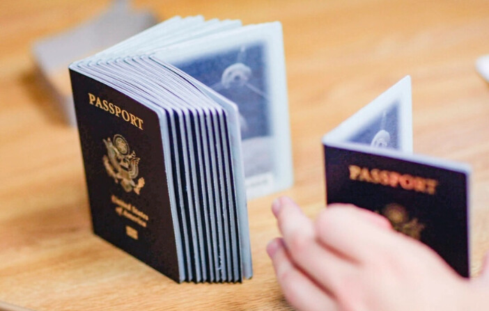 Un empleado de tramitación de pasaportes con una pila de pasaportes en blanco en la Agencia de Pasaportes de Miami, Florida, el 22 de junio de 2007. (Joe Raedle/Getty Images). 