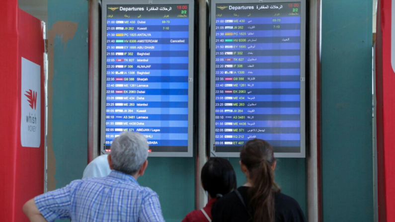 Varias personas miran los paneles de información de vuelos en el aeropuerto internacional Beirut-Rafic Hariri en Beirut, Líbano, el 28 de julio de 2024. (Mohamed Azakir/Reuters)