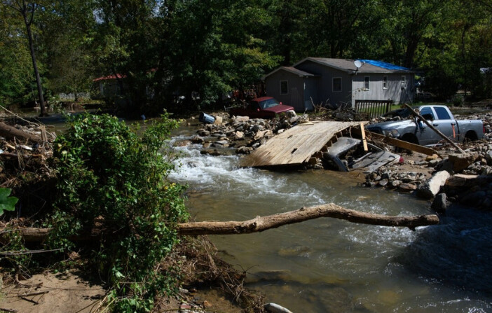 El 2 de octubre de 2024, en Black Mountain, Carolina del Norte, se observan daños en viviendas y vehículos, así como el desvío de los cursos de agua. Se puede ver la carretera arrasada por las aguas de la inundación frente a su propiedad. Según los informes, al menos 160 personas han muerto en el sureste de EE.UU., y más de un millón están sin electricidad debido a la tormenta. La Casa Blanca ha aprobado declaraciones de catástrofe en varios estados del sur, liberando dinero y recursos federales para la gestión de emergencias. (Melissa Sue Gerrits/Getty Images). 