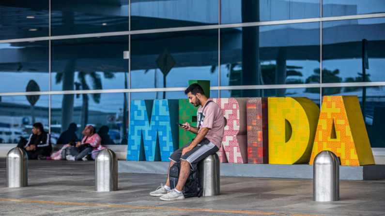 Turistas varados en el aeropuerto Manuel Crecencio Rejón de Mérida permanecen afuera después de que el aeropuerto fuera cerrado antes de la llegada del huracán Milton en Mérida, estado de Yucatán, México, el 7 de octubre de 2024. (Hugo Borges/AFP vía Getty Images)