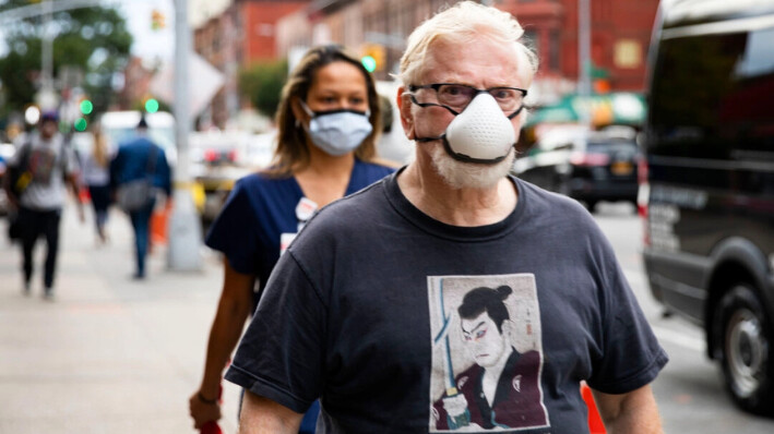 Personas con mascarillas caminando por la calle, en una foto de archivo. Chung I Ho/The Epoch Times