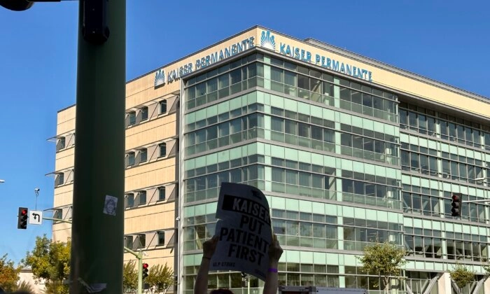 Empleados de Kaiser Permanente caminan en una línea de piquete frente al hospital de la coalición de atención médica sin fines de lucro en Oakland, California, el 4 de octubre de 2023. (Jill McLaughlin/The Epoch Times)