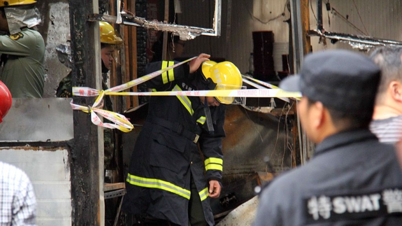 Los bomberos investigan la escena después de una explosión de gas en un restaurante en Wuhu, en la provincia china de Anhui, el 10 de octubre de 2015. (STR/AFP vía Getty Images)