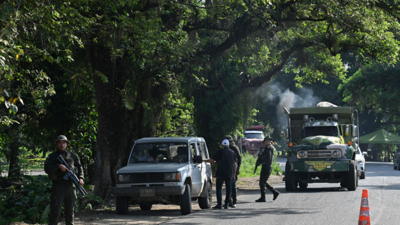 Un oficial de policía inspecciona un vehículo en un punto de control la mañana después de una explosión cerca de una comisaría en una carretera de Jamundí, departamento del Valle del Cauca, Colombia, el 17 de octubre de 2024. (Joaquin Sarmiento/AFP vía Getty Images)