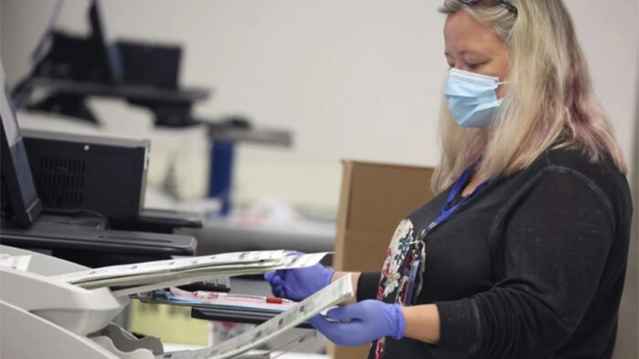 Una trabajadora electoral escanea las papeletas de voto por correo en el Centro de Elecciones y Tabulación del Condado de Maricopa en Phoenix, Arizona, el 7 de noviembre de 2022. (Justin Sullivan/Getty Images)