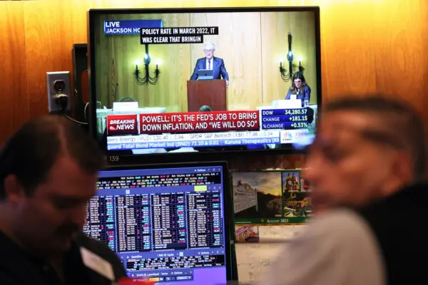 El discurso del presidente de la Reserva Federal, Jerome Powell, se ve en una pantalla de televisión mientras los operadores trabajan en el parqué de la Bolsa de Nueva York durante las operaciones de la mañana del 25 de agosto de 2023. (Michael M. Santiago/Getty Images)