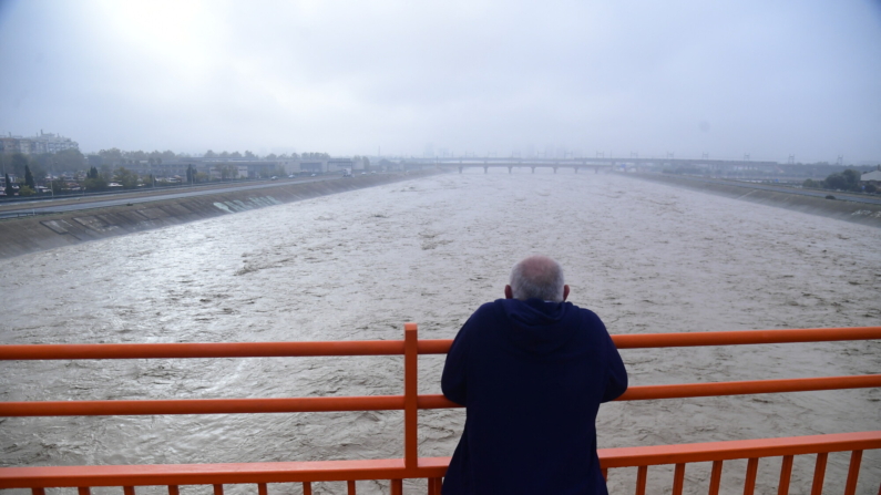 Un hombre observa el alto nivel del río Turia tras las inundaciones en Valencia, este de España, el 30 de octubre de 2024.  (Foto de JOSE JORDAN/AFP via Getty Images)