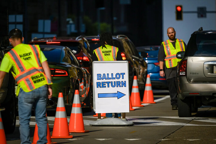 Empleados de Obras Públicas del Condado de Allegheny guían a los votantes a la devolución de papeletas del condado fuera del Edificio de Oficinas del Condado de Allegheny, en Pittsburgh, el 29 de octubre de 2024. (Jeff Swensen/Getty Images)