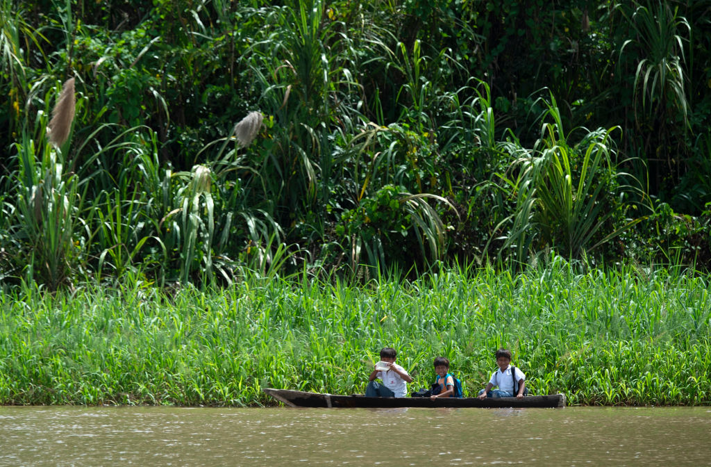 As crianças vão à escola de canoa no rio Maranon, um dos principais afluentes do rio Amazonas, na Reserva Nacional Pacaya Samiria, em 24 de maio de 2019 (CRIS BOURONCLE / AFP / Getty Images)