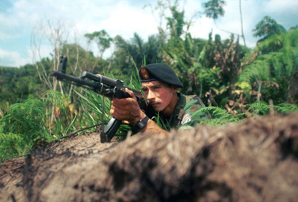 Um guerrilheiro das Forças Armadas Revolucionárias da Colômbia (FARC) vigia uma estrada em 7 de março de 2002 nas montanhas perto de Bogotá, Sumapaz, Colômbia (Carlos Villalon / Getty Images)
