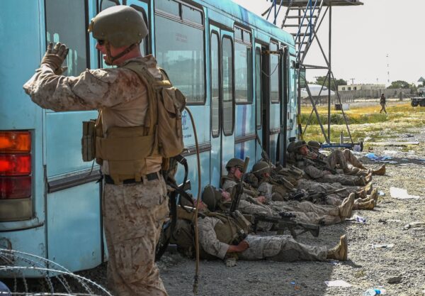 Soldados estadounidenses descansan mientras los afganos esperan para salir del aeropuerto de Kabul, en Kabul, el 16 de agosto de 2021. (Wakil Kohsar/AFP vía Getty Images)